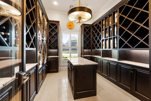 wine area with visible vents, light tile patterned floors, ornamental molding, and recessed lighting