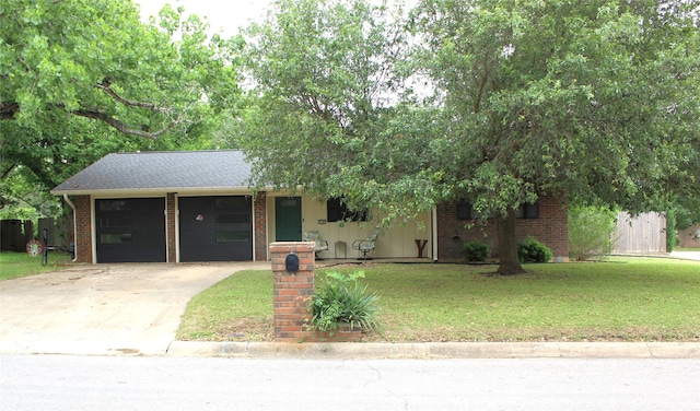 ranch-style house featuring brick siding, a front yard, and driveway