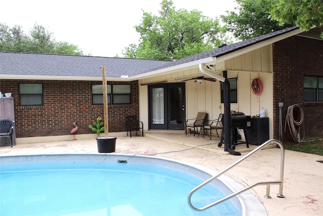 outdoor pool with a ceiling fan and a patio area