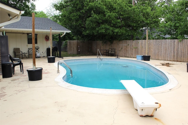 view of pool featuring a fenced in pool, a diving board, a patio, and a fenced backyard