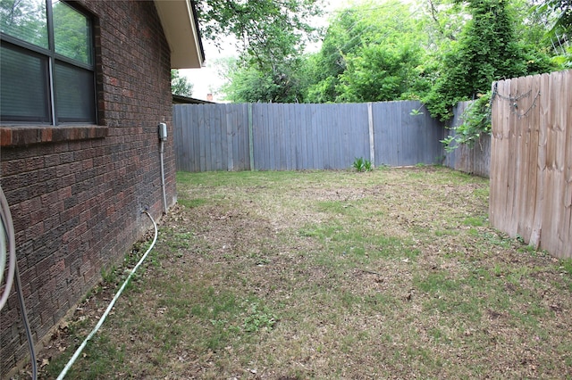 view of yard with a fenced backyard