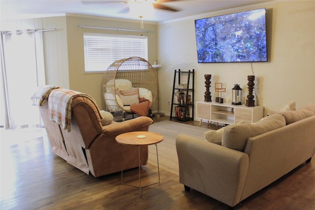 living room with wood finished floors, a ceiling fan, and crown molding