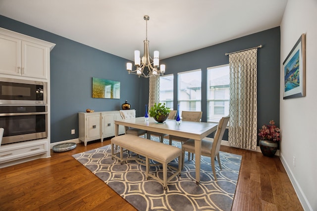 8218 Laflin Ln, Dallas, TX 75231 - dining room with an inviting chandelier, baseboards, and dark wood-style flooring