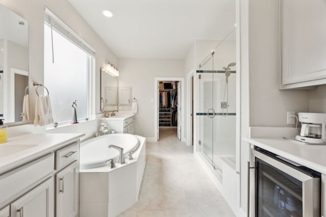 8218 Laflin Ln, Dallas, TX 75231 - bathroom with a garden tub, a stall shower, beverage cooler, and two vanities