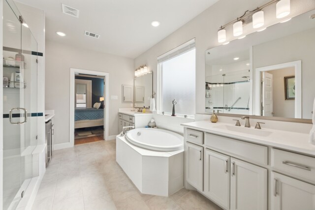8218 Laflin Ln, Dallas, TX 75231 - bathroom with connected bathroom, a sink, a shower stall, visible vents, and a bath