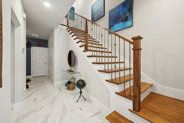 8218 Laflin Ln, Dallas, TX 75231 - staircase with baseboards, visible vents, recessed lighting, and marble finish floor