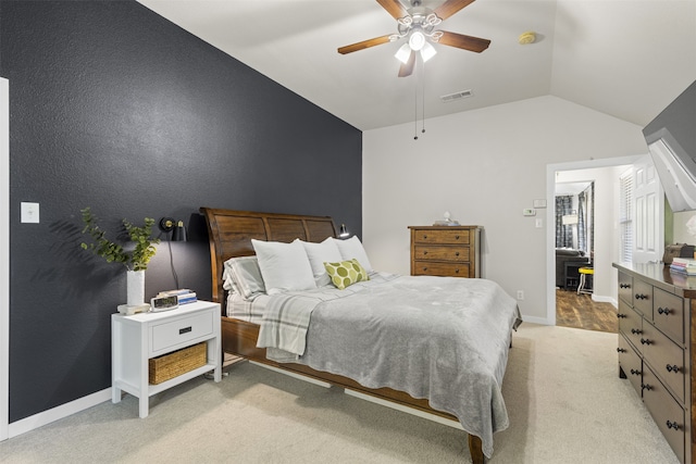 bedroom with a ceiling fan, visible vents, light colored carpet, baseboards, and lofted ceiling
