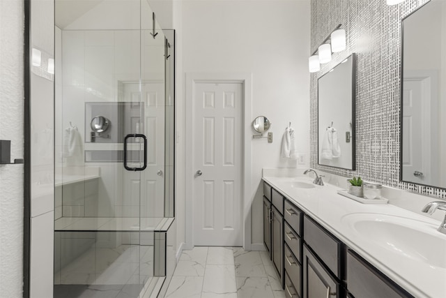 full bath with a sink, a stall shower, double vanity, and marble finish floor