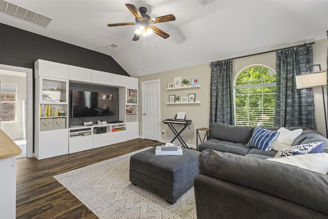 living area with dark wood-style flooring, a ceiling fan, visible vents, and lofted ceiling
