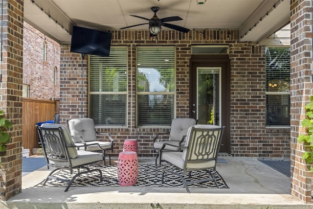 view of patio with fence and a ceiling fan