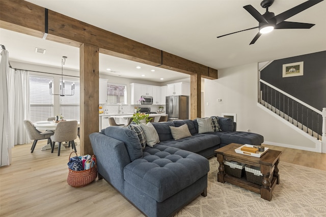 living room featuring a ceiling fan, visible vents, light wood-type flooring, stairway, and recessed lighting