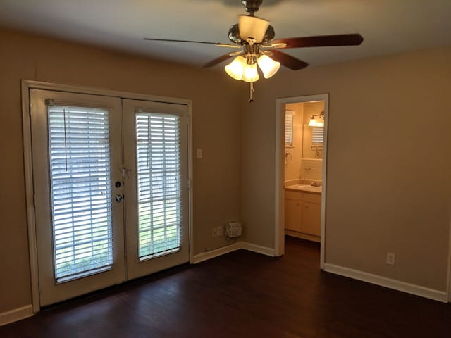 unfurnished room with dark wood-type flooring, french doors, and plenty of natural light