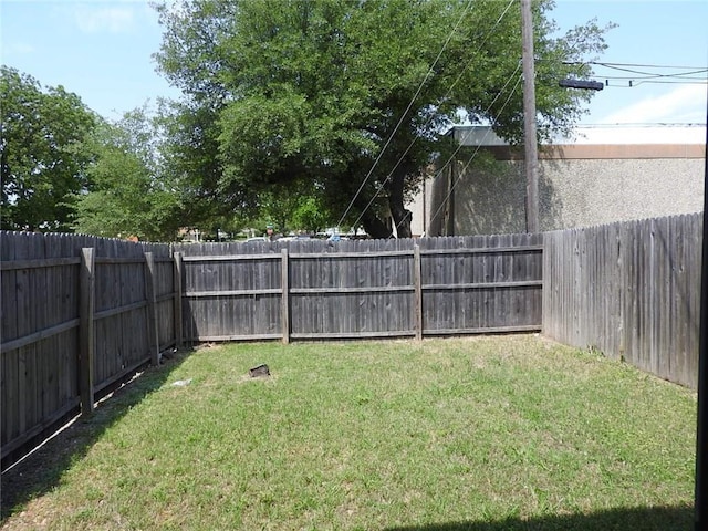 view of yard with a fenced backyard