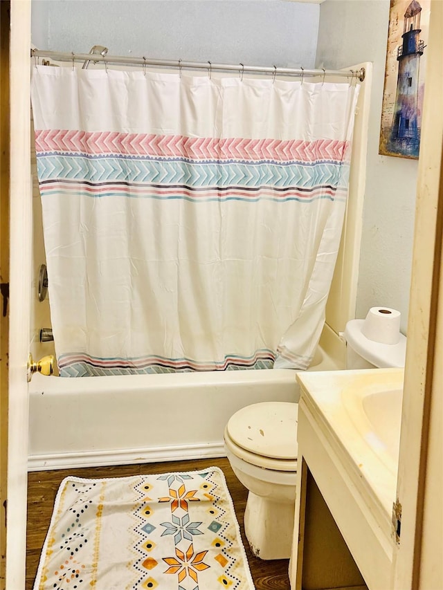 1406 N Main St, Weatherford, TX 76086 - full bath featuring vanity, shower / bathtub combination with curtain, and wood finished floors