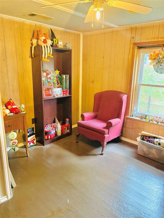 1406 N Main St, Weatherford, TX 76086 - sitting room with wood walls, a ceiling fan, and wood finished floors
