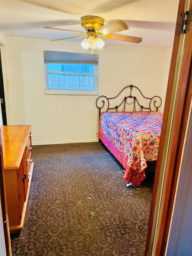 1406 N Main St, Weatherford, TX 76086 - bedroom featuring a ceiling fan and dark colored carpet