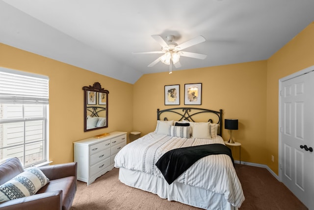 bedroom featuring baseboards, a ceiling fan, lofted ceiling, and light colored carpet