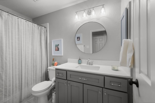 bathroom with toilet, vanity, and a shower with shower curtain