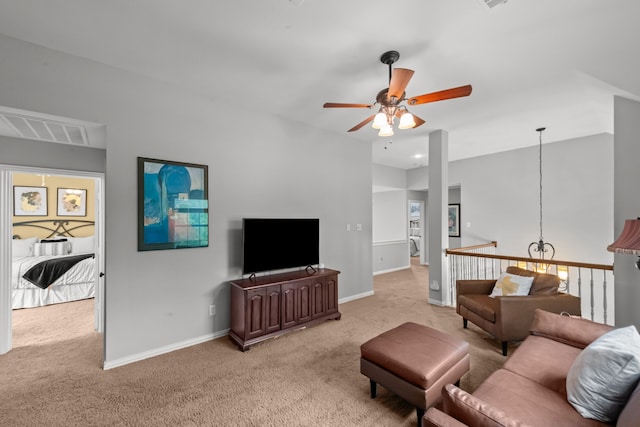 living area featuring visible vents, ceiling fan, light colored carpet, and baseboards