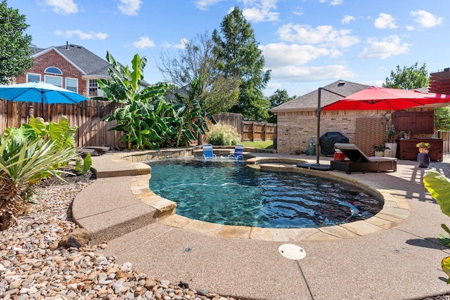 view of pool with a fenced in pool, a patio, a fenced backyard, and an in ground hot tub