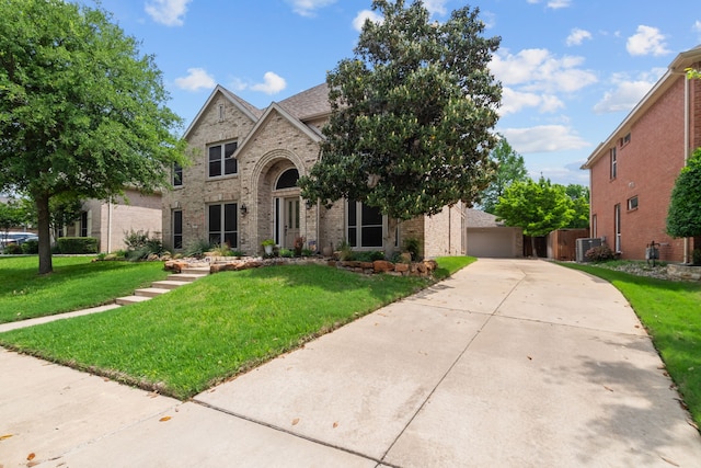 traditional-style home with a front yard and brick siding