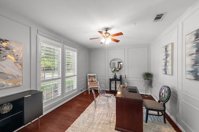 home office featuring visible vents, ceiling fan, plenty of natural light, and a decorative wall