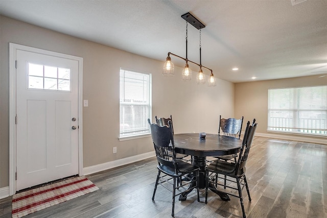 dining area featuring wood finished floors, recessed lighting, and baseboards