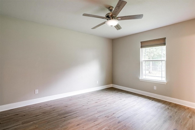 empty room with wood finished floors and baseboards