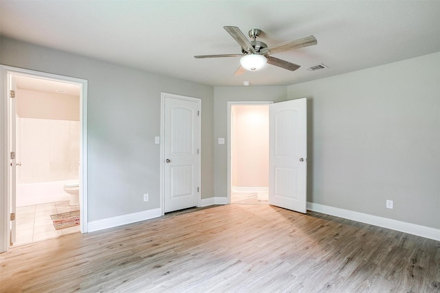 unfurnished bedroom featuring baseboards, visible vents, and light wood-type flooring
