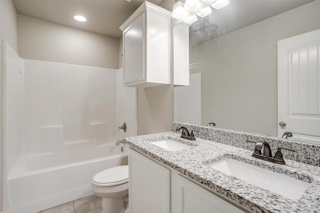 full bath featuring toilet, tile patterned flooring, a sink, and double vanity