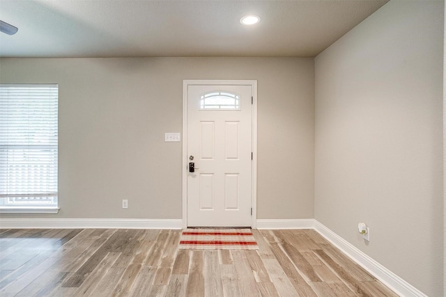 foyer featuring baseboards, recessed lighting, and light wood-style flooring