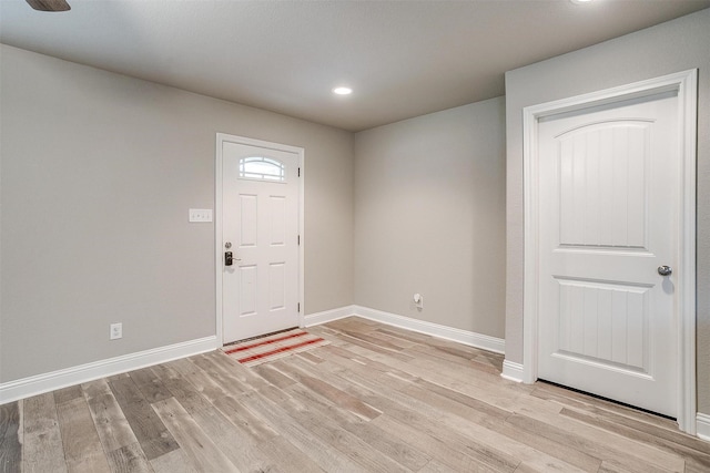 foyer entrance featuring baseboards, recessed lighting, and light wood-style floors