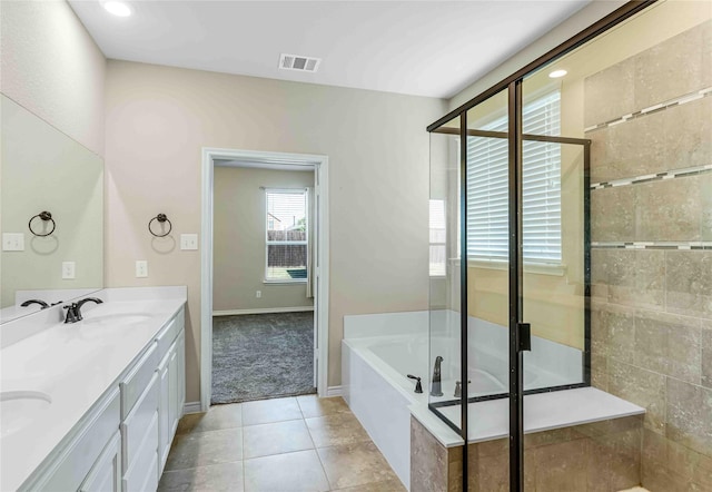 bathroom featuring a tile shower, a bath, tile patterned flooring, and a sink