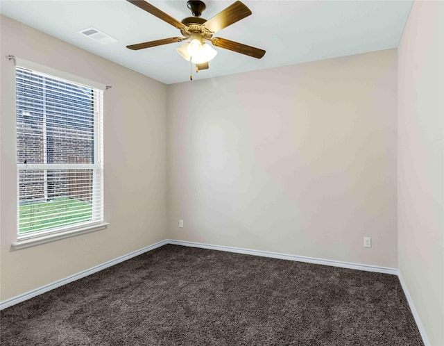 carpeted spare room featuring visible vents, ceiling fan, and baseboards