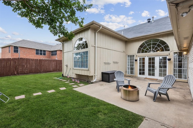 rear view of property with a patio area, fence, french doors, a yard, and an outdoor fire pit