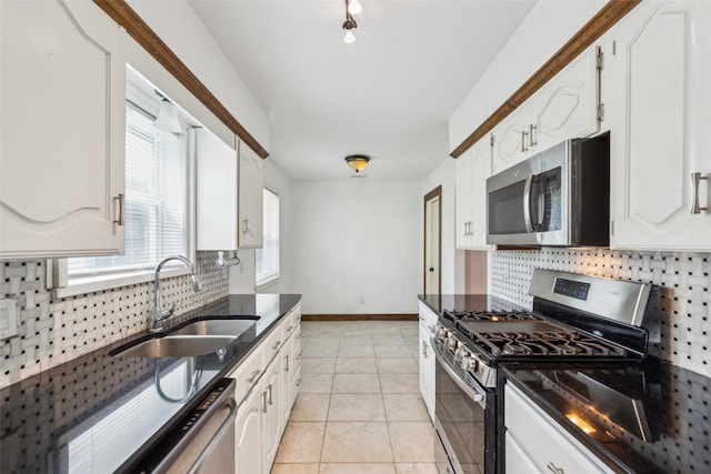 416 Cambridge Dr, Richardson, TX 75080 - kitchen with appliances with stainless steel finishes, a sink, dark stone countertops, tasteful backsplash, and white cabinetry