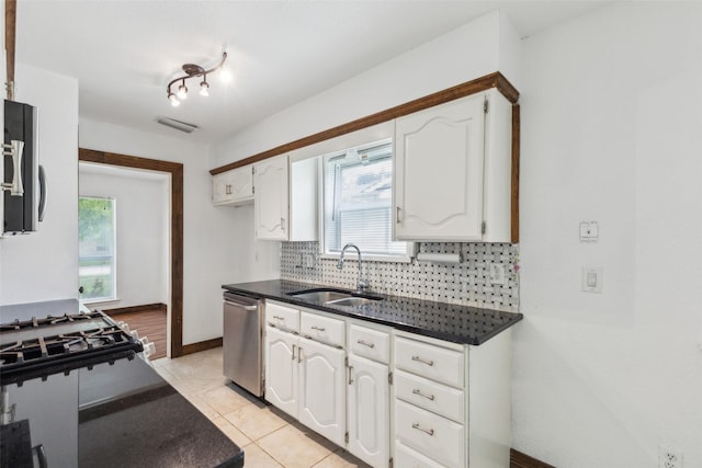 416 Cambridge Dr, Richardson, TX 75080 - kitchen featuring stainless steel appliances, a sink, white cabinetry, decorative backsplash, and plenty of natural light