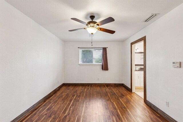 416 Cambridge Dr, Richardson, TX 75080 - empty room featuring dark wood-style floors, a ceiling fan, and baseboards