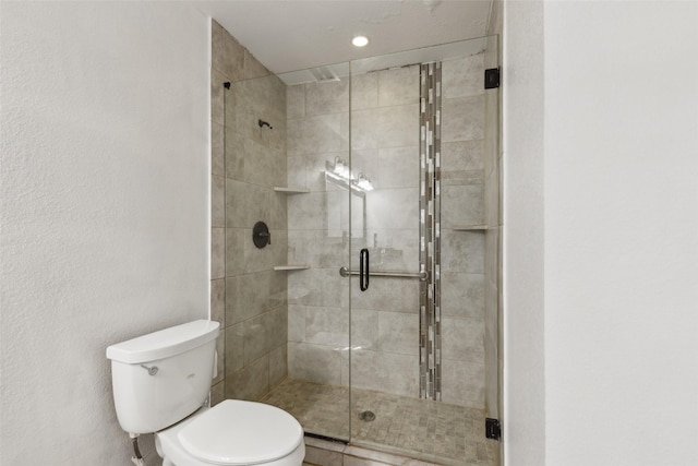 bathroom with a stall shower and toilet