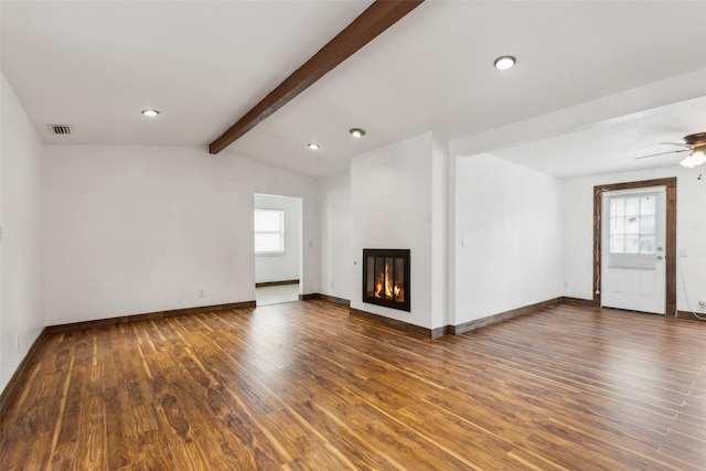 unfurnished living room featuring visible vents, wood finished floors, and a healthy amount of sunlight