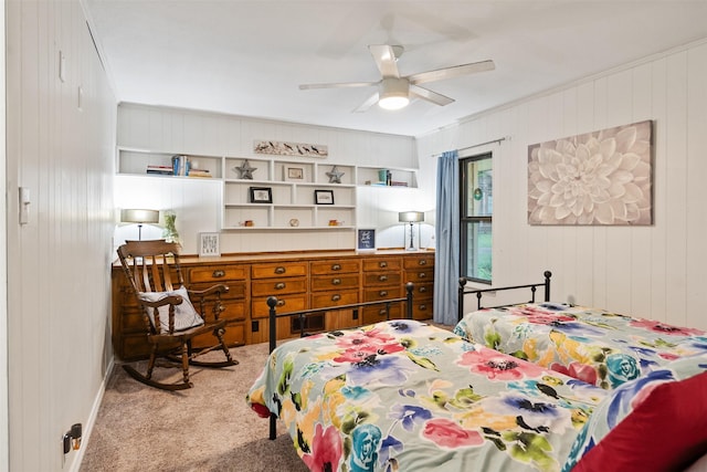 bedroom with wood walls, ceiling fan, and carpet floors