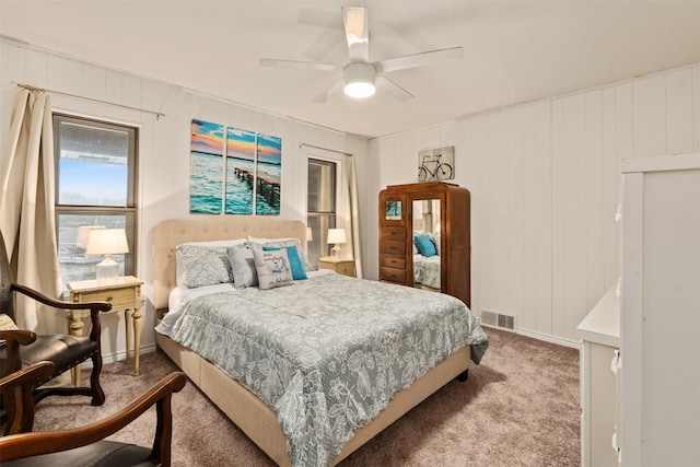carpeted bedroom featuring baseboards, visible vents, and a ceiling fan