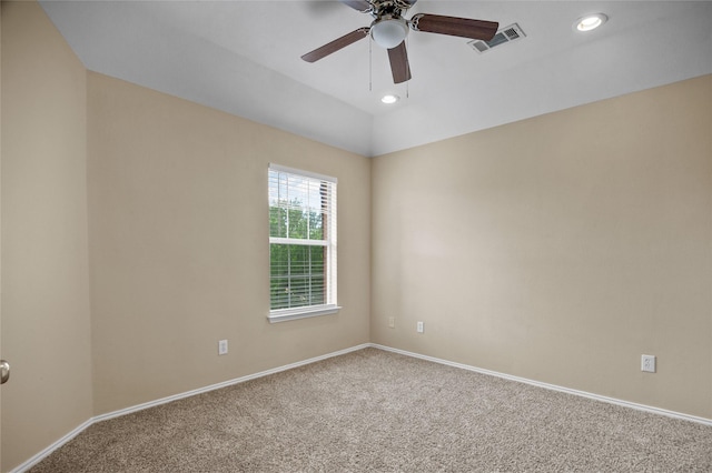empty room featuring carpet, visible vents, a ceiling fan, and baseboards
