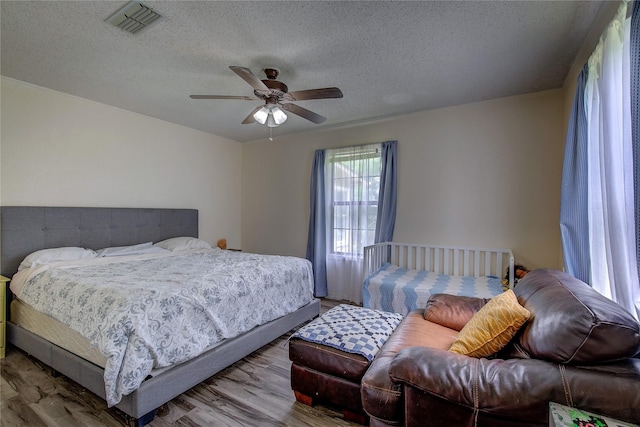 1829 County Road 1103, Sulphur Springs, TX 75482 - full bath featuring wood finished floors, vanity, a textured wall, toilet, and a textured ceiling