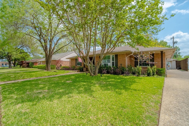 ranch-style home featuring brick siding and a front yard