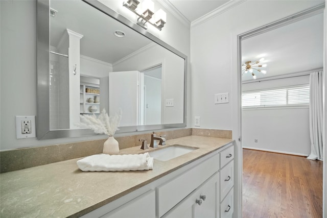 bathroom featuring visible vents, ornamental molding, wood finished floors, and vanity