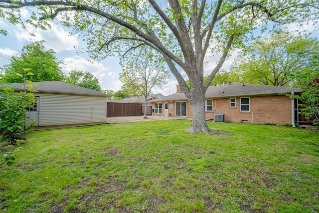 view of yard featuring a patio, central air condition unit, and fence