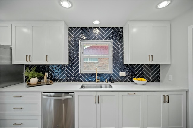 kitchen featuring stainless steel dishwasher, a sink, white cabinetry, and light countertops