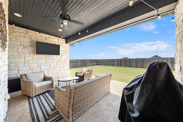 view of patio featuring a ceiling fan, outdoor lounge area, and a fenced backyard