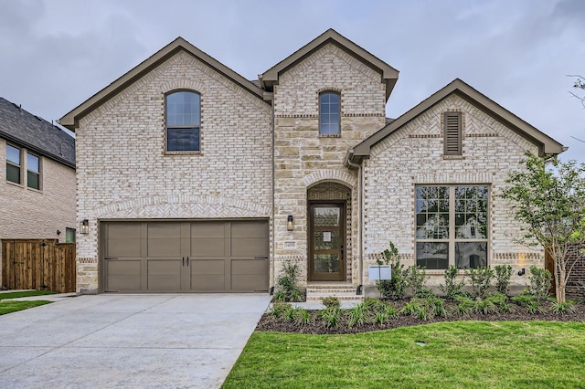 16090 Inca Dove Ct, Frisco, TX 75035 - french country style house featuring driveway, an attached garage, and brick siding